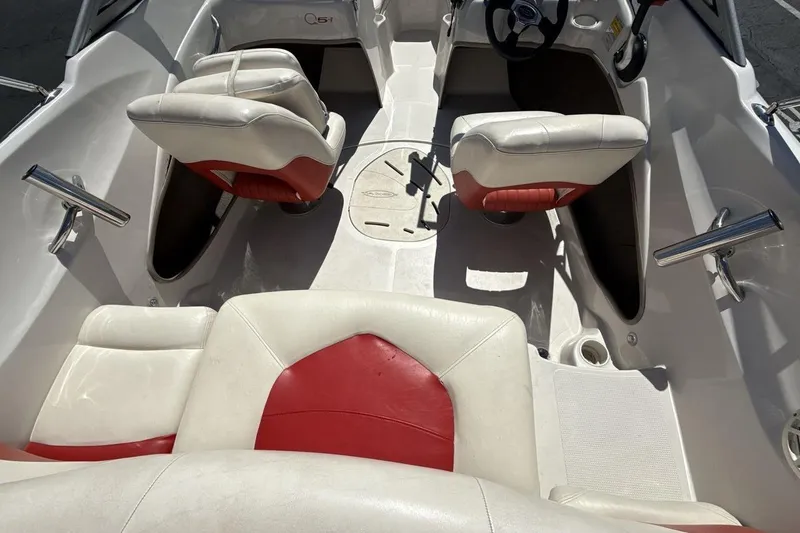 Slide: The Image of 2008 Tahoe Q5i SF boat interior with white and red seating, steering wheel visible. - 10