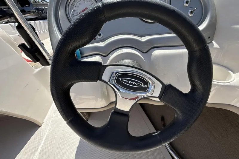 Slide: The Image of Steering wheel of a 2008 Tahoe Q5i SF boat, featuring a sleek dashboard design. - 14