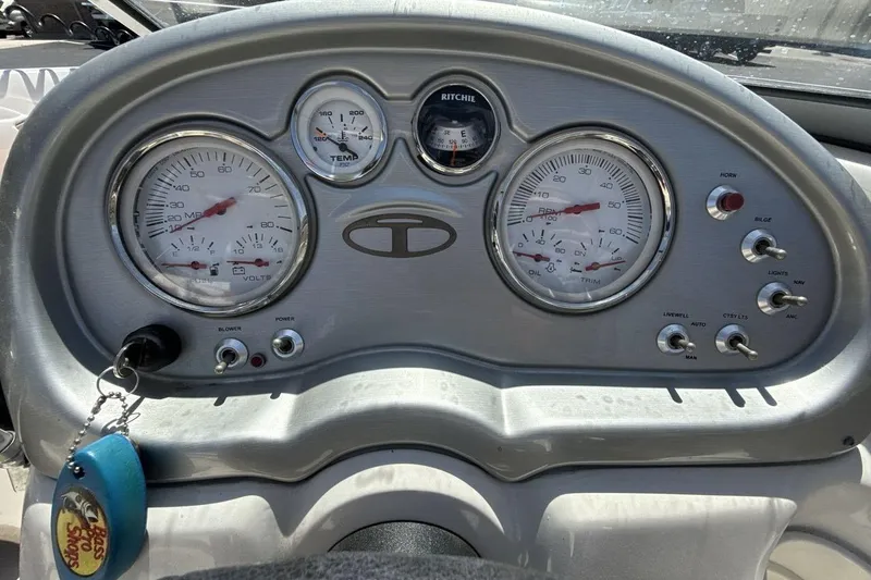 Slide: The Image of Dashboard of a 2008 Tahoe Q5i SF boat with gauges and controls. - 15