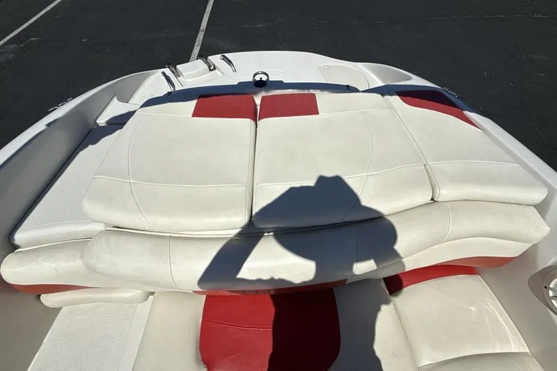 Slide: The Image of 2008 Tahoe Q5i SF boat interior with white and red seating, shadow visible. - 19