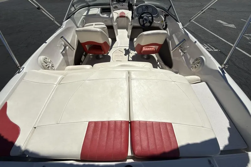 Slide: The Image of 2008 Tahoe Q5i SF boat interior with white and red seating, steering wheel, and dashboard. - 9