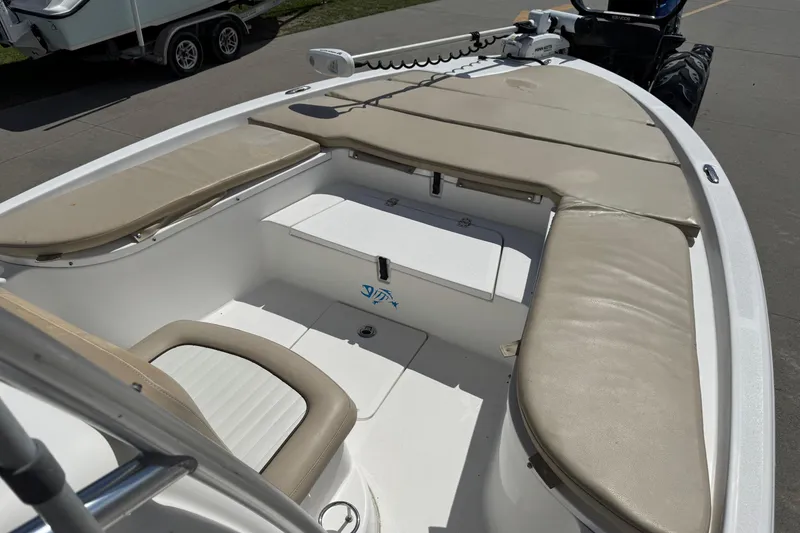 Slide: The Image of 2015 Sea Fox 220 Viper boat interior with beige seating and storage compartments. - 12