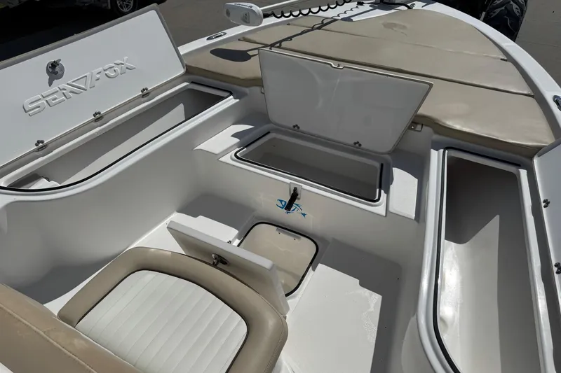 Slide: The Image of 2015 Sea Fox 220 Viper boat interior with open storage compartments and seating. - 14