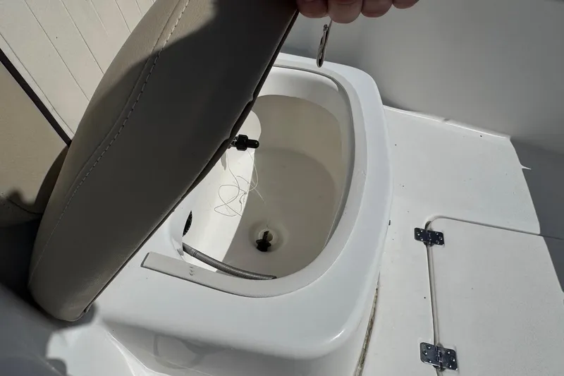 Slide: The Image of 2015 Sea Fox 220 Viper boat seat storage compartment open, showing interior details. - 16