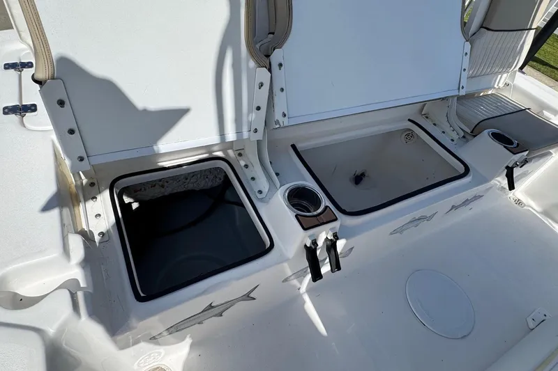 Slide: The Image of 2015 Sea Fox 220 Viper boat interior with open storage compartments and cup holders. - 21