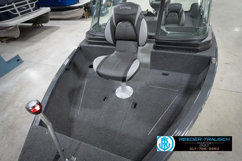 Slide: The Image of 2026 Lund 1650 Rebel XL Sport boat interior with seating and carpeted deck. - 10