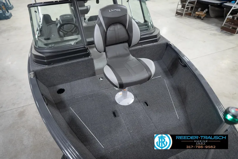 Slide: The Image of 2026 Lund 1650 Rebel XL Sport boat interior with swivel seat, showcased at Reeder-Trausch Marine. - 11