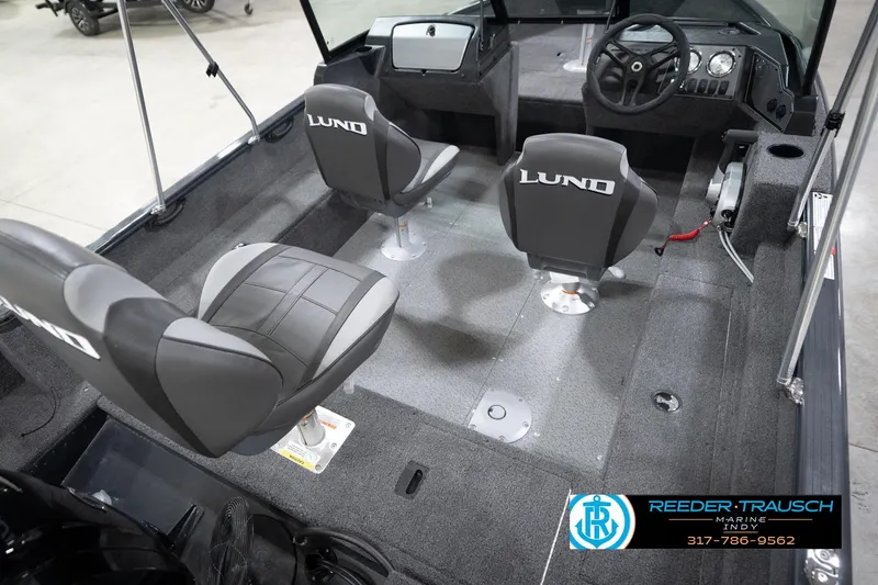 Slide: The Image of 2026 Lund 1650 Rebel XL Sport boat interior with seating and steering console. - 12