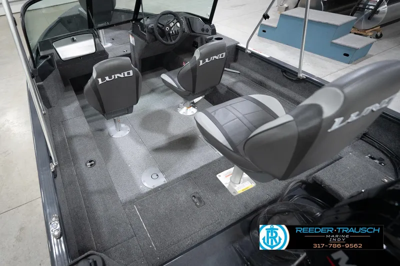 Slide: The Image of 2026 Lund 1650 Rebel XL Sport boat interior with seating and steering console. - 13