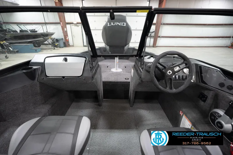 Slide: The Image of Interior view of 2026 Lund 1650 Rebel XL Sport boat, featuring steering wheel and seating. - 15