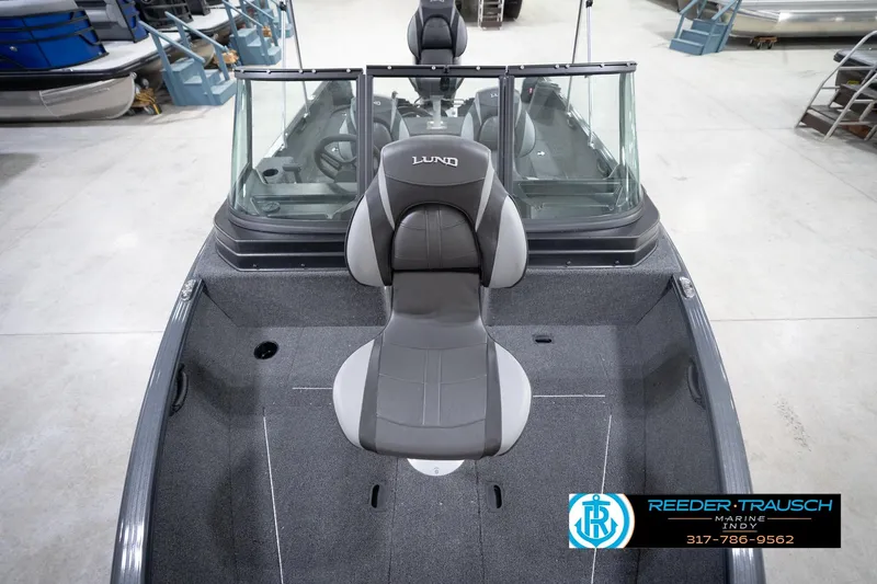 Slide: The Image of 2026 Lund 1650 Rebel XL Sport boat interior with seating, displayed at Reeder-Trausch Marine. - 17