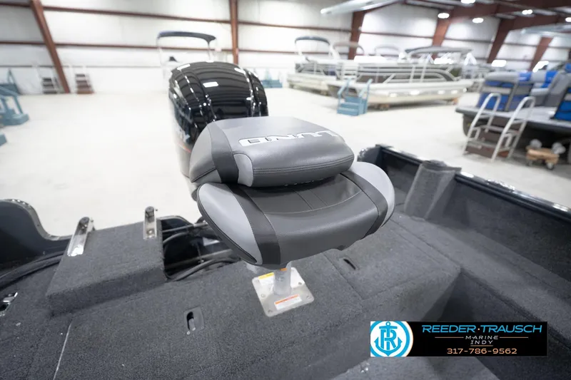 Slide: The Image of 2026 Lund 1650 Rebel XL Sport boat seat in showroom, featuring sleek design and comfortable padding. - 21