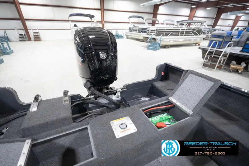 Slide: The Image of 2026 Lund 1650 Rebel XL Sport boat interior with Mercury engine in showroom. - 23