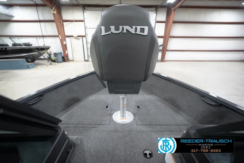 Slide: The Image of 2026 Lund 1650 Rebel XL Sport boat interior with branded seat in a showroom. - 28