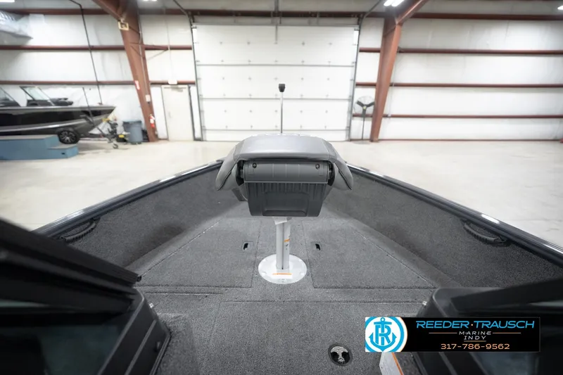 Slide: The Image of 2026 Lund 1650 Rebel XL Sport boat interior in a spacious garage setting. - 29