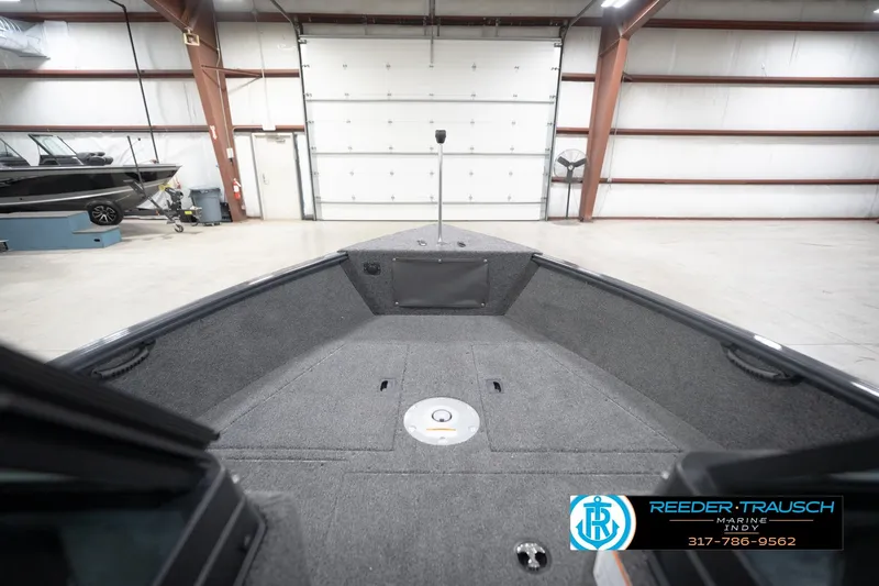 Slide: The Image of 2026 Lund 1650 Rebel XL Sport boat interior in a spacious garage setting. - 30