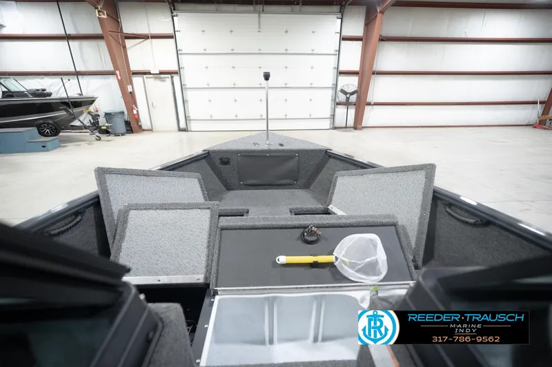 Slide: The Image of 2026 Lund 1650 Rebel XL Sport boat interior in a spacious garage setting. - 31