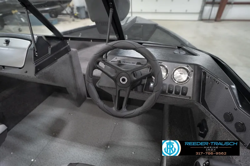Slide: The Image of 2026 Lund 1650 Rebel XL Sport boat interior with steering wheel and dashboard controls. - 32