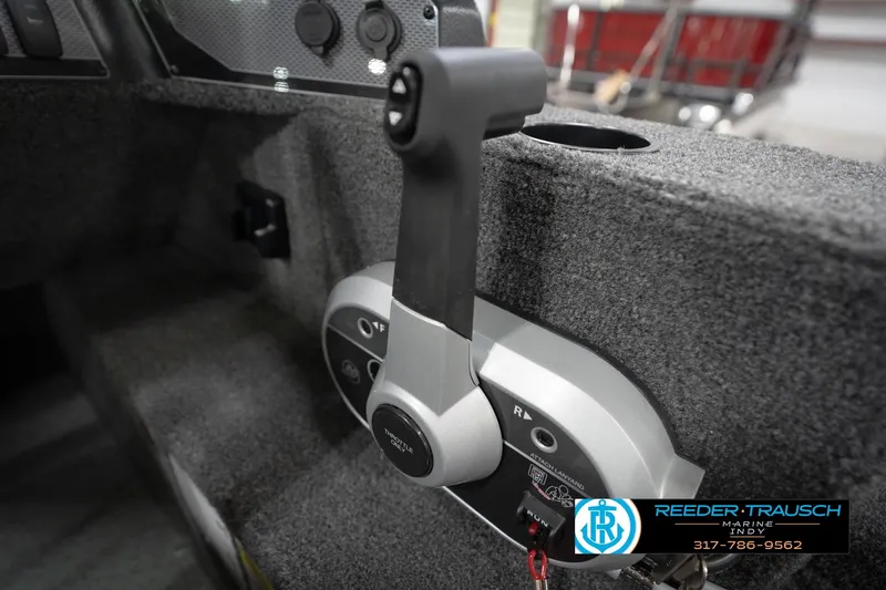 Slide: The Image of 2026 Lund 1650 Rebel XL Sport boat throttle control in cockpit, Reeder-Trausch Marine branding. - 38