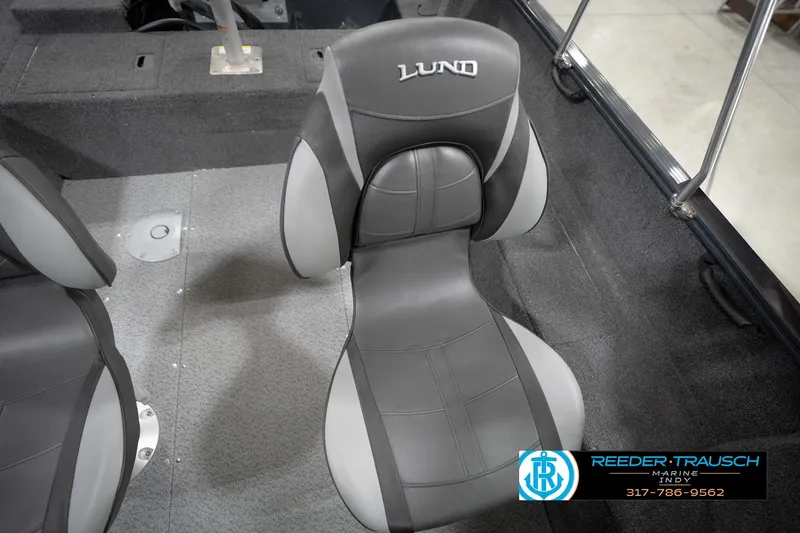 Slide: The Image of 2026 Lund 1650 Rebel XL Sport boat interior with gray seating and carpeted flooring. - 41