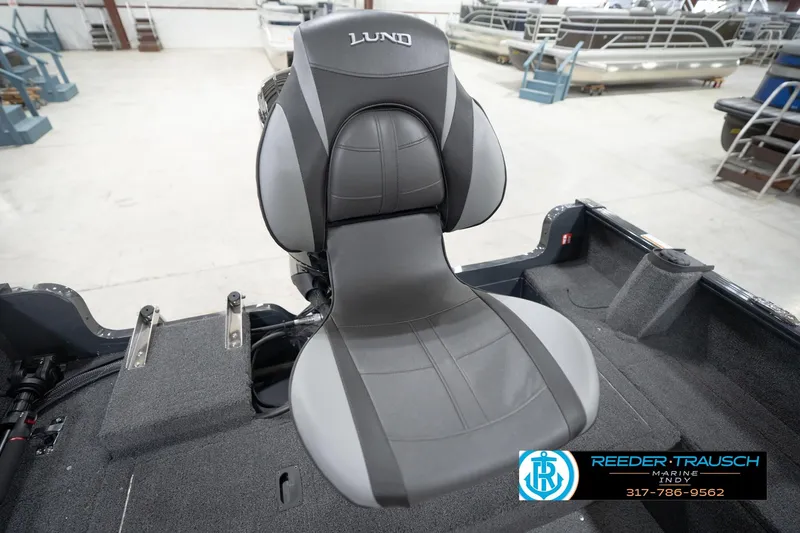Slide: The Image of 2026 Lund 1650 Rebel XL Sport boat seat in showroom, featuring gray upholstery. - 42