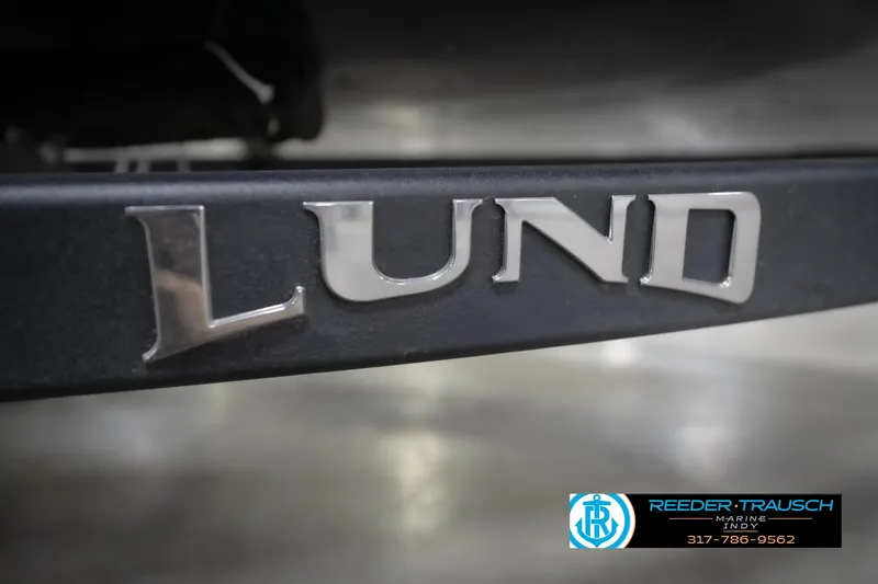 Slide: The Image of Close-up of 2026 Lund 1650 Rebel XL Sport boat logo with dealership contact. - 54