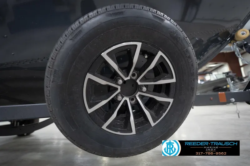 Slide: The Image of 2026 Lund 1650 Rebel XL Sport trailer wheel with black and silver alloy rim. - 55