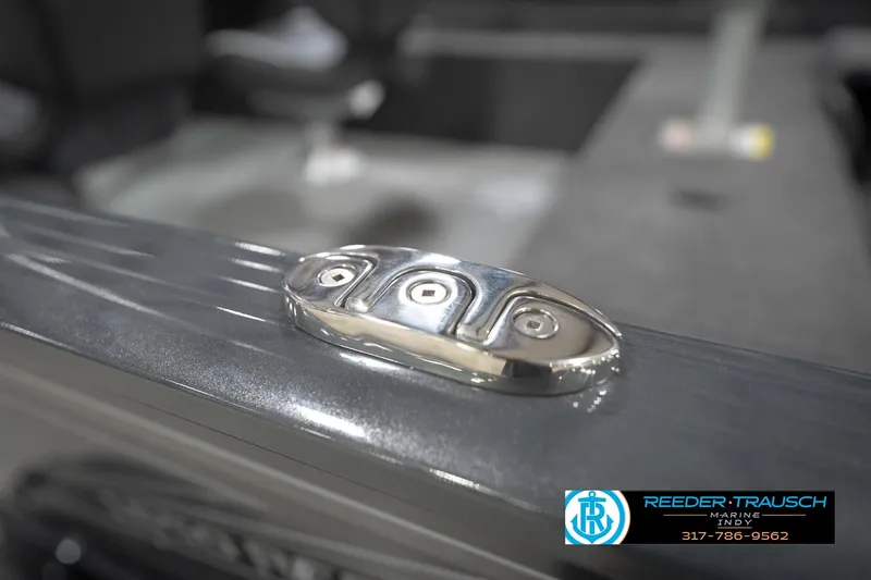 Slide: The Image of 2026 Lund 1650 Rebel XL Sport boat detail with chrome hardware, Reeder Trausch Marine logo. - 57