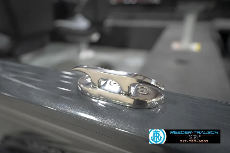 Slide: The Image of 2026 Lund 1650 Rebel XL Sport boat cleat detail, Reeder Trausch Marine logo visible. - 58