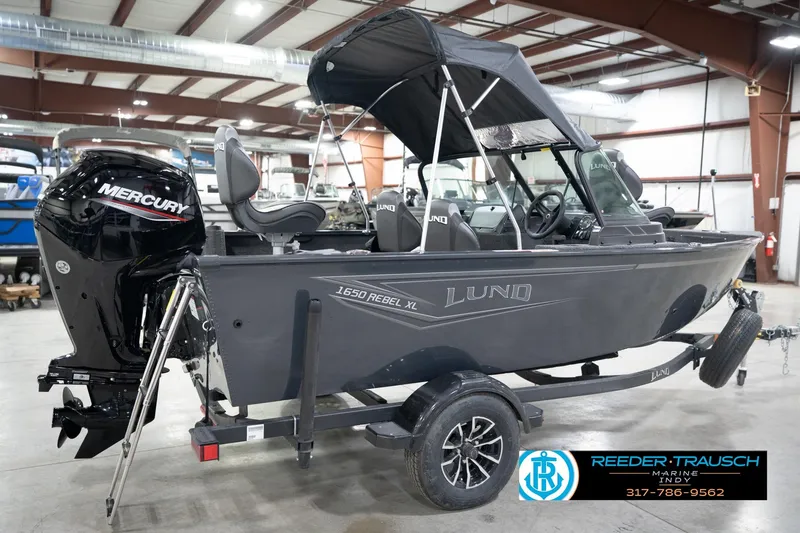 Slide: The Image of 2026 Lund 1650 Rebel XL Sport boat with Mercury engine in showroom. - 6