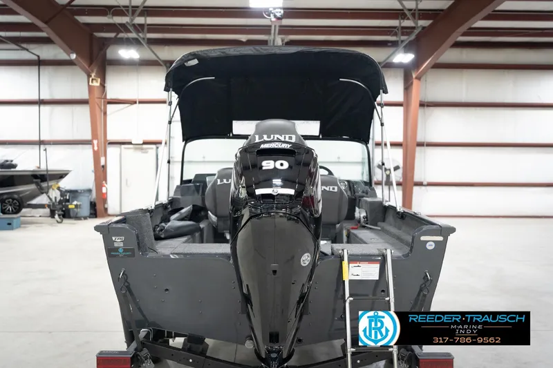 Slide: The Image of 2026 Lund 1650 Rebel XL Sport boat with Mercury 90 engine in a showroom. - 7