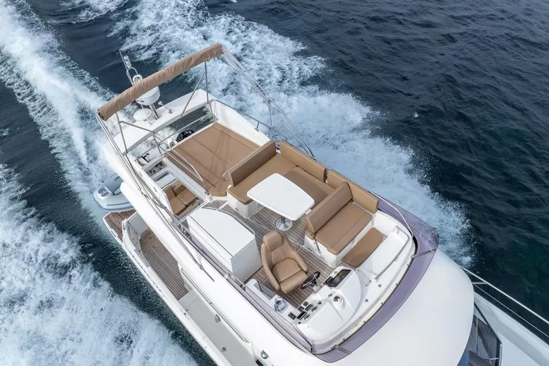 Slide: The Image of 2016 Jeanneau Velasco 43F yacht cruising on open water, aerial view. - 10