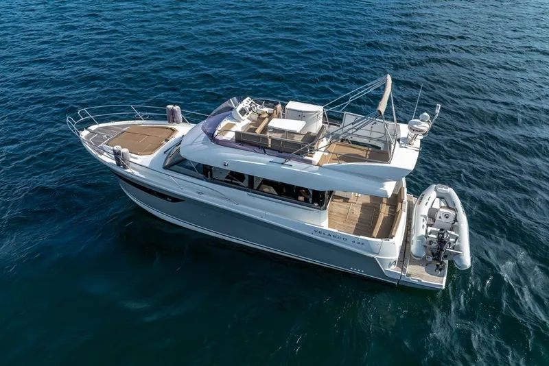 Slide: The Image of 2016 Jeanneau Velasco 43F yacht cruising on open water, aerial view. - 12