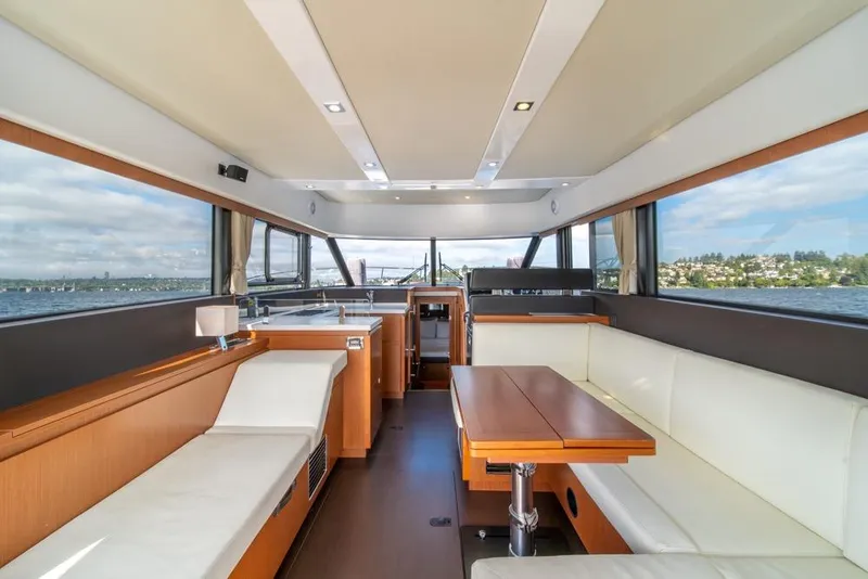 Slide: The Image of Interior of 2016 Jeanneau Velasco 43F yacht with modern seating and panoramic windows. - 13