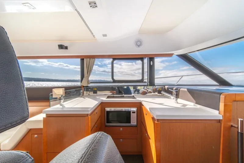 Slide: The Image of Interior of 2016 Jeanneau Velasco 43F yacht with modern kitchen and ocean view. - 17