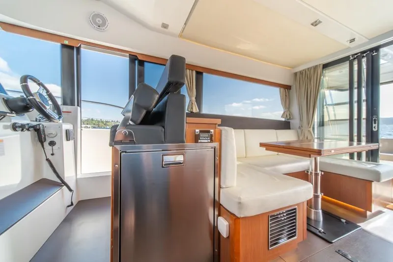 Slide: The Image of Interior of 2016 Jeanneau Velasco 43F yacht with helm, seating, and dining area. - 18