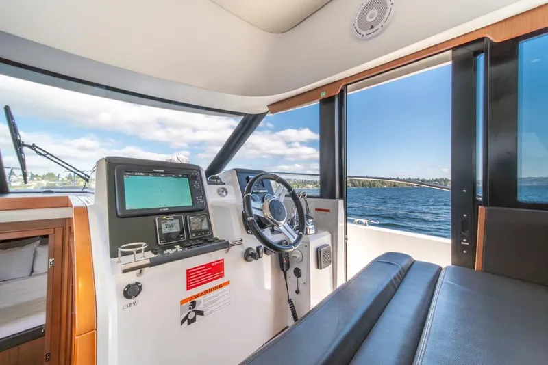 Slide: The Image of Interior view of 2016 Jeanneau Velasco 43F yacht helm with navigation equipment. - 19
