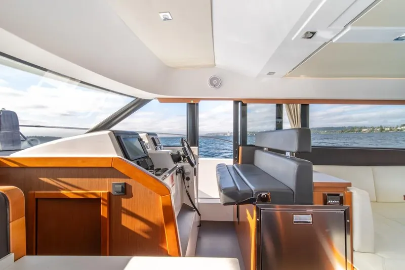 Slide: The Image of Interior of 2016 Jeanneau Velasco 43F yacht with modern helm and seating, overlooking the sea. - 22