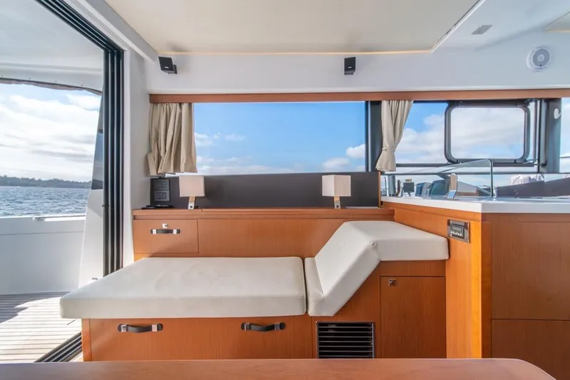 Slide: The Image of Interior of 2016 Jeanneau Velasco 43F yacht with modern seating and ocean view. - 23
