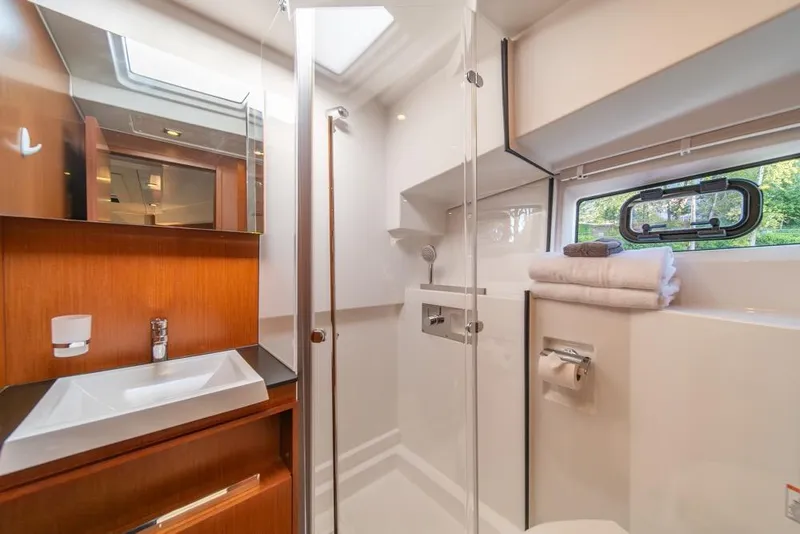 Slide: The Image of Luxurious bathroom in 2016 Jeanneau Velasco 43F yacht with modern fixtures and natural light. - 27