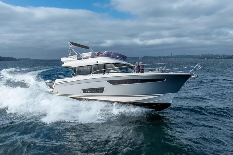Slide: The Image of 2016 Jeanneau Velasco 43F yacht cruising on open water under cloudy skies. - 3