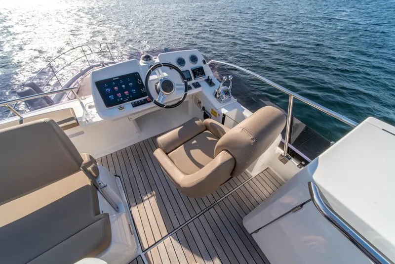 Slide: The Image of Flybridge helm of 2016 Jeanneau Velasco 43F yacht with modern controls and ocean view. - 38