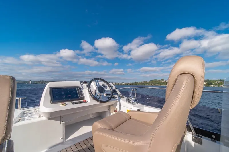 Slide: The Image of Flybridge helm of 2016 Jeanneau Velasco 43F yacht under clear blue sky. - 39