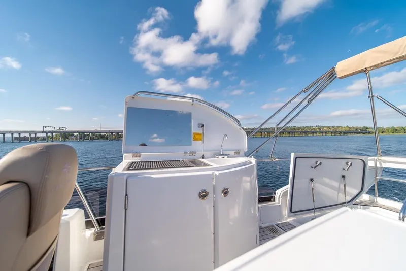 Slide: The Image of 2016 Jeanneau Velasco 43F yacht deck with scenic water view and clear skies. - 40