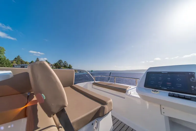 Slide: The Image of Flybridge view from 2016 Jeanneau Velasco 43F yacht, featuring seating and navigation console. - 42