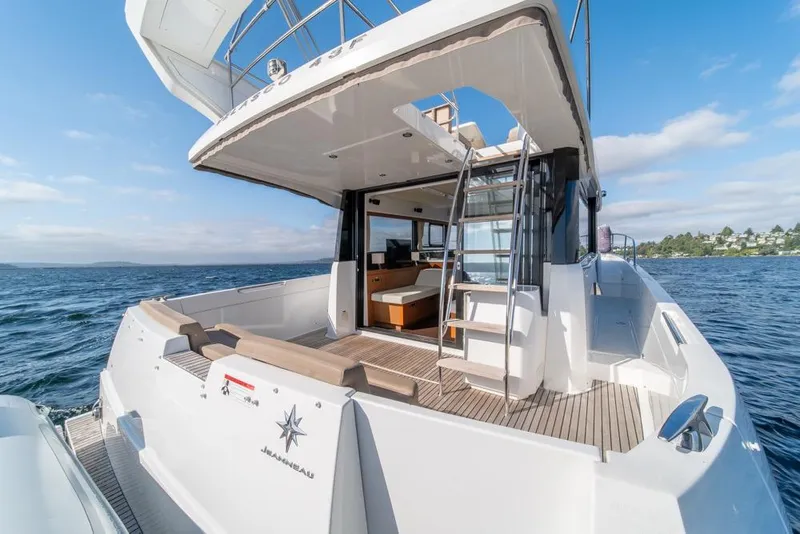 Slide: The Image of 2016 Jeanneau Velasco 43F yacht on open water, showcasing spacious deck and modern design. - 45