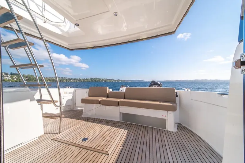 Slide: The Image of 2016 Jeanneau Velasco 43F yacht deck with seating, ocean view, and stairs. - 46
