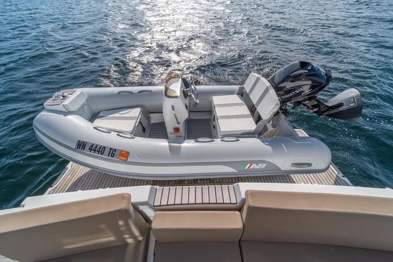 Slide: The Image of Inflatable boat with outboard motor on Jeanneau Velasco 43F yacht, 2016 model, on open water. - 48