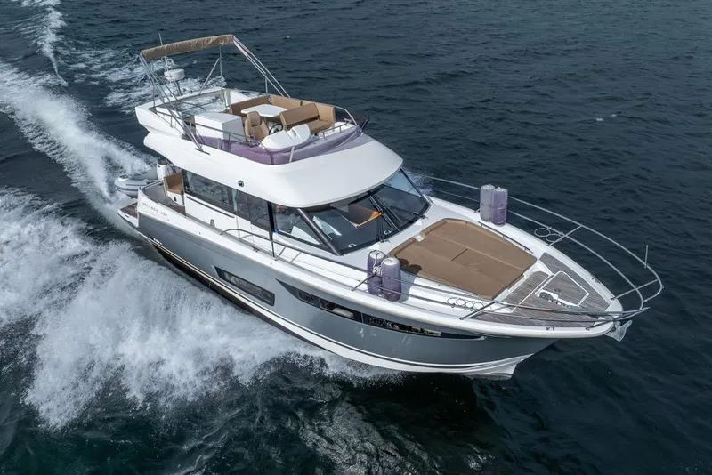 Slide: The Image of 2016 Jeanneau Velasco 43F yacht cruising on open water. - 5