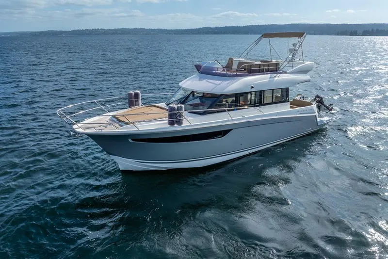 Slide: The Image of 2016 Jeanneau Velasco 43F yacht cruising on open water under clear skies. - 52